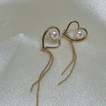 CAELLIA 18k gold plated heart-shaped dangle earrings featuring a single pearl on each.