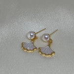 Caellia 14K gold earrings featuring a freshwater pearl and a mother-of-pearl fan charm.