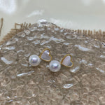 Caellia 14K gold stud earrings featuring a heart-shaped fritillaria shell and a freshwater pearl.