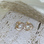 Caellia Camellia flower stud earrings featuring a central freshwater pearl and gold-tone petals.