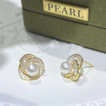 CAELLIA Camellia flower stud earrings featuring a central freshwater pearl and gold-tone petals.