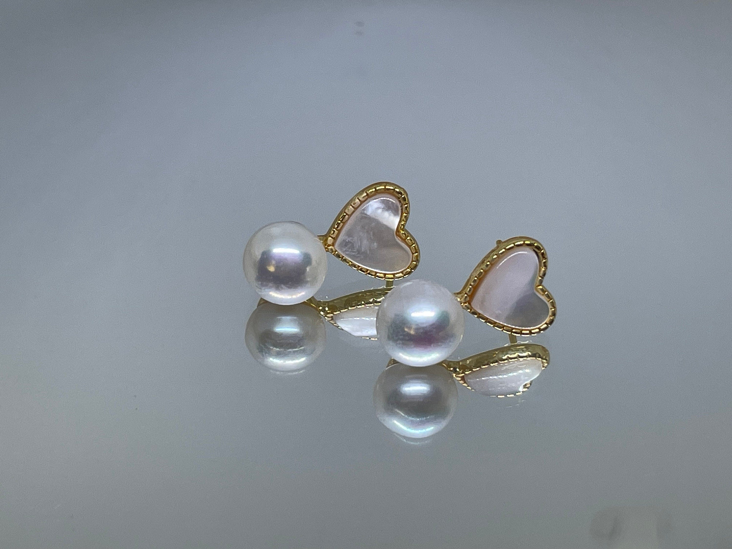 Caellia 14K gold stud earrings featuring a freshwater pearl paired with a heart-shaped shell.