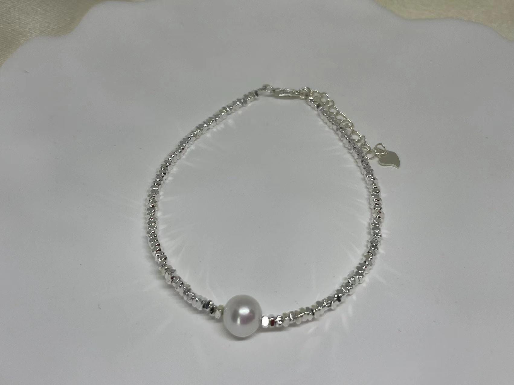 CAELLIA freshwater pearl bracelet with a 925 sterling silver beaded chain on a white background.