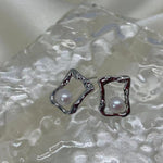 CAELLIA silver stud earrings featuring a freshwater pearl inside a textured square frame.