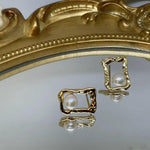 CAELLIA gold plated stud earrings featuring a lustrous freshwater pearl in a textured square frame.