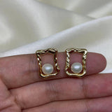 CAELLIA gold plated stud earrings featuring a freshwater pearl set in a textured quadrate frame.