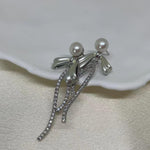 CAELLIA pearl bow dangle earrings crafted from 925 sterling silver with freshwater pearls.
