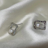 CAELLIA silver stud earrings featuring a lustrous freshwater pearl inside a textured square frame.