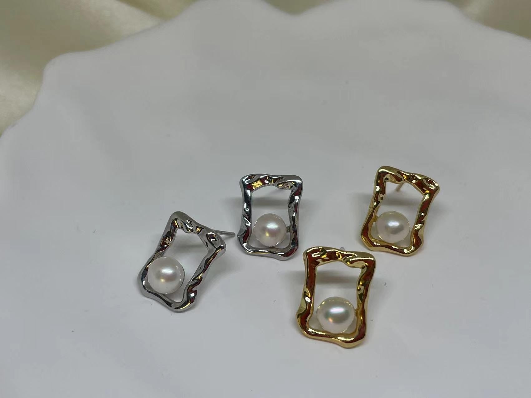 CAELLIA freshwater pearl square stud earrings in gold and silver on a white surface.