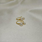 Caellia 18K gold plated stud earrings featuring two delicate freshwater pearls.