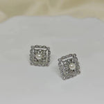 CAELLIA sterling silver square stud earrings featuring a central pearl framed by small diamonds.