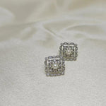 CAELLIA sterling silver square stud earrings featuring a central freshwater pearl and diamond accents.