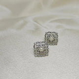 CAELLIA sterling silver square stud earrings featuring a central freshwater pearl and diamond accents.