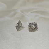 CAELLIA sterling silver square stud earrings featuring a central freshwater pearl and diamond accents.