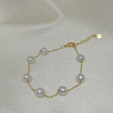 CAELLIA freshwater pearl bracelet featuring seven pearls on a gold-plated sterling silver chain.