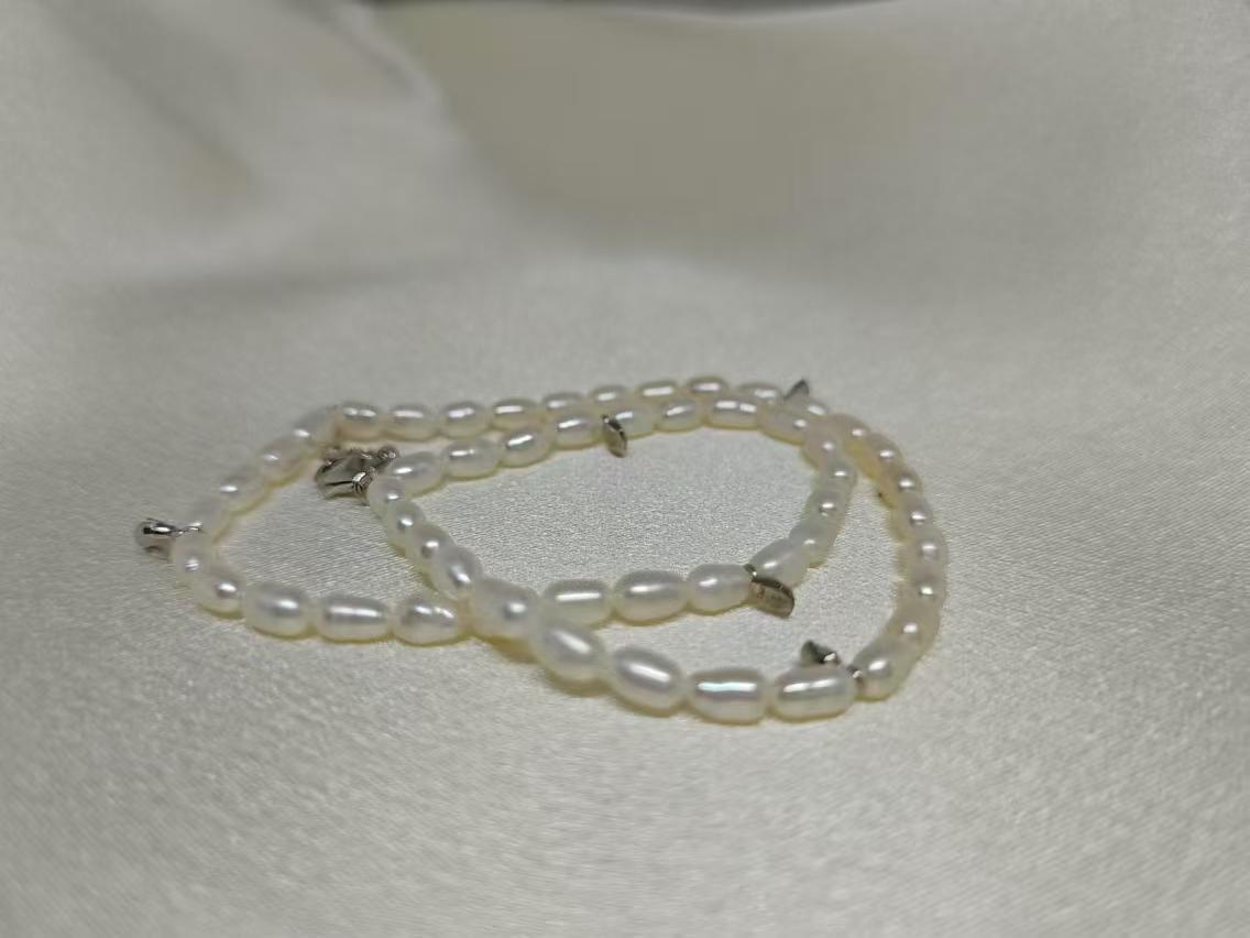 CAELLIA double wrapped freshwater pearl bracelet with gold plated sterling silver accents.
