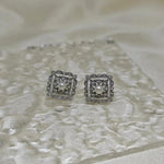 CAELLIA sterling silver square stud earrings featuring a central freshwater pearl and diamond accents.