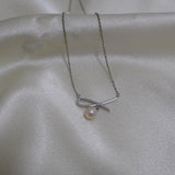CAELLIA dainty freshwater pearl pendant necklace featuring a delicate bow design on a silver chain.