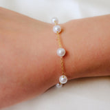 CAELLIA freshwater pearl bracelet featuring seven pearls on a gold-plated sterling silver chain.