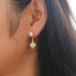 Caellia 14K gold earrings featuring a freshwater pearl stud and a mother-of-pearl fan drop.