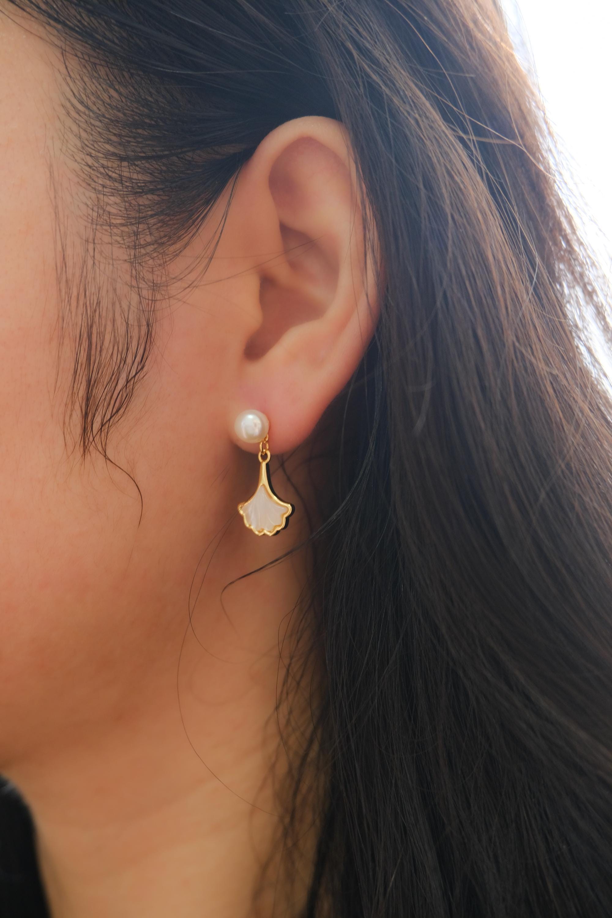 Caellia 14K gold earrings featuring a freshwater pearl stud and a mother-of-pearl fan drop.
