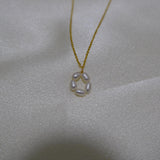 CAELLIA gold plated necklace featuring a delicate flower pendant made of five freshwater pearls.