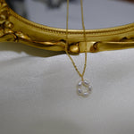 CAELLIA gold plated necklace featuring a delicate flower pendant made of small freshwater pearls.