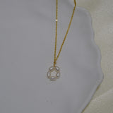 CAELLIA gold plated necklace featuring a delicate flower pendant made of freshwater pearls.
