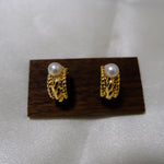 Caellia 14K gold huggie hoop earrings featuring a vintage braided design and freshwater pearls.