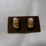 Caellia 14K gold huggie hoop earrings featuring a vintage braided design and freshwater pearls.