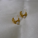 Caellia 14K gold huggie hoop earrings featuring a textured finish and a freshwater pearl.