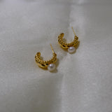 Caellia 14K gold huggie hoop earrings featuring a textured finish and a freshwater pearl.