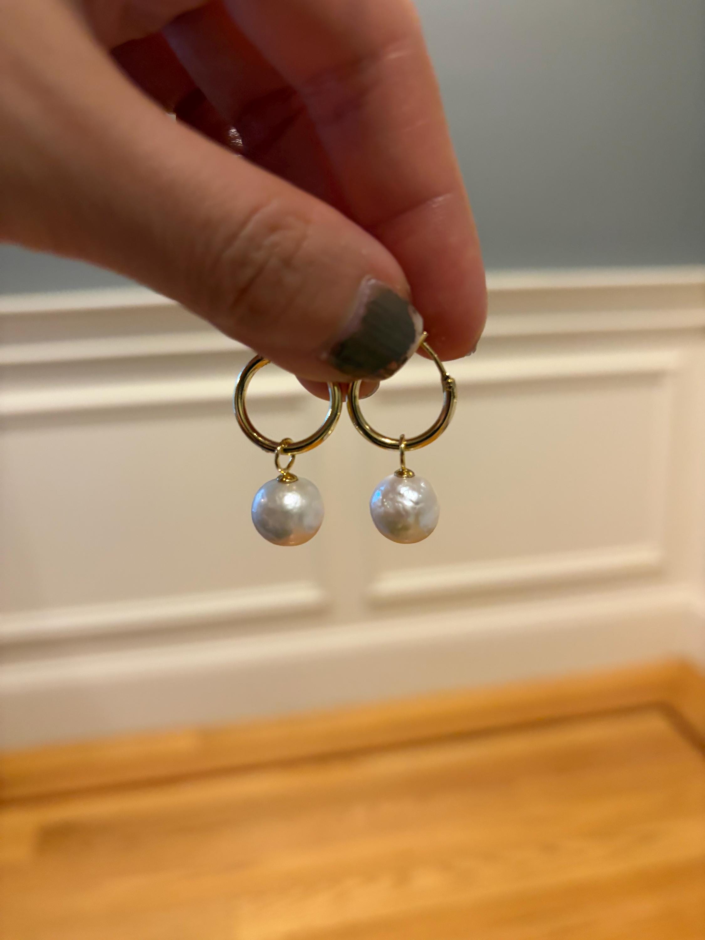 Caellia 18K gold hoop earrings featuring a single dangling freshwater pearl.