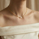 A Caellia 18K gold paperclip chain necklace featuring a single baroque freshwater pearl.