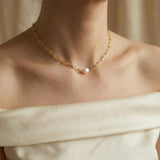 A Caellia 18K gold paperclip chain necklace featuring a single baroque freshwater pearl.