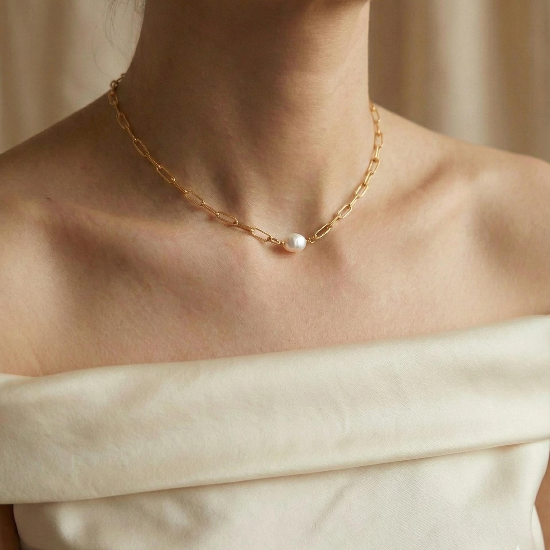A Caellia 18K gold paperclip chain necklace featuring a single baroque freshwater pearl.
