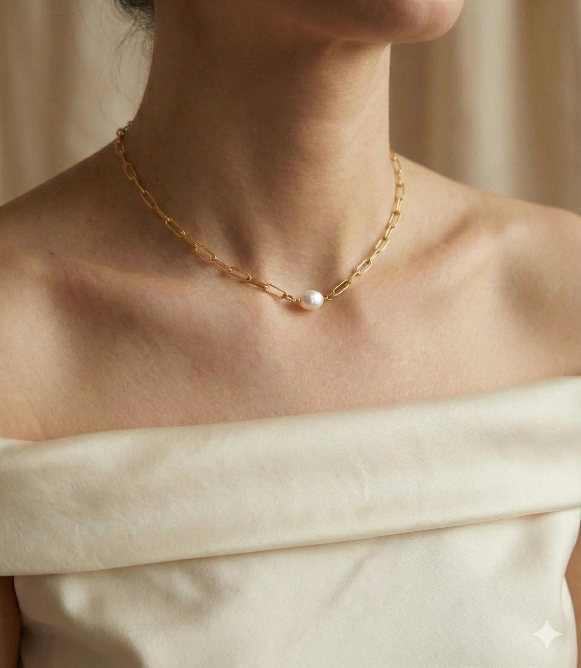 A Caellia 18K gold paperclip chain necklace featuring a single baroque freshwater pearl.