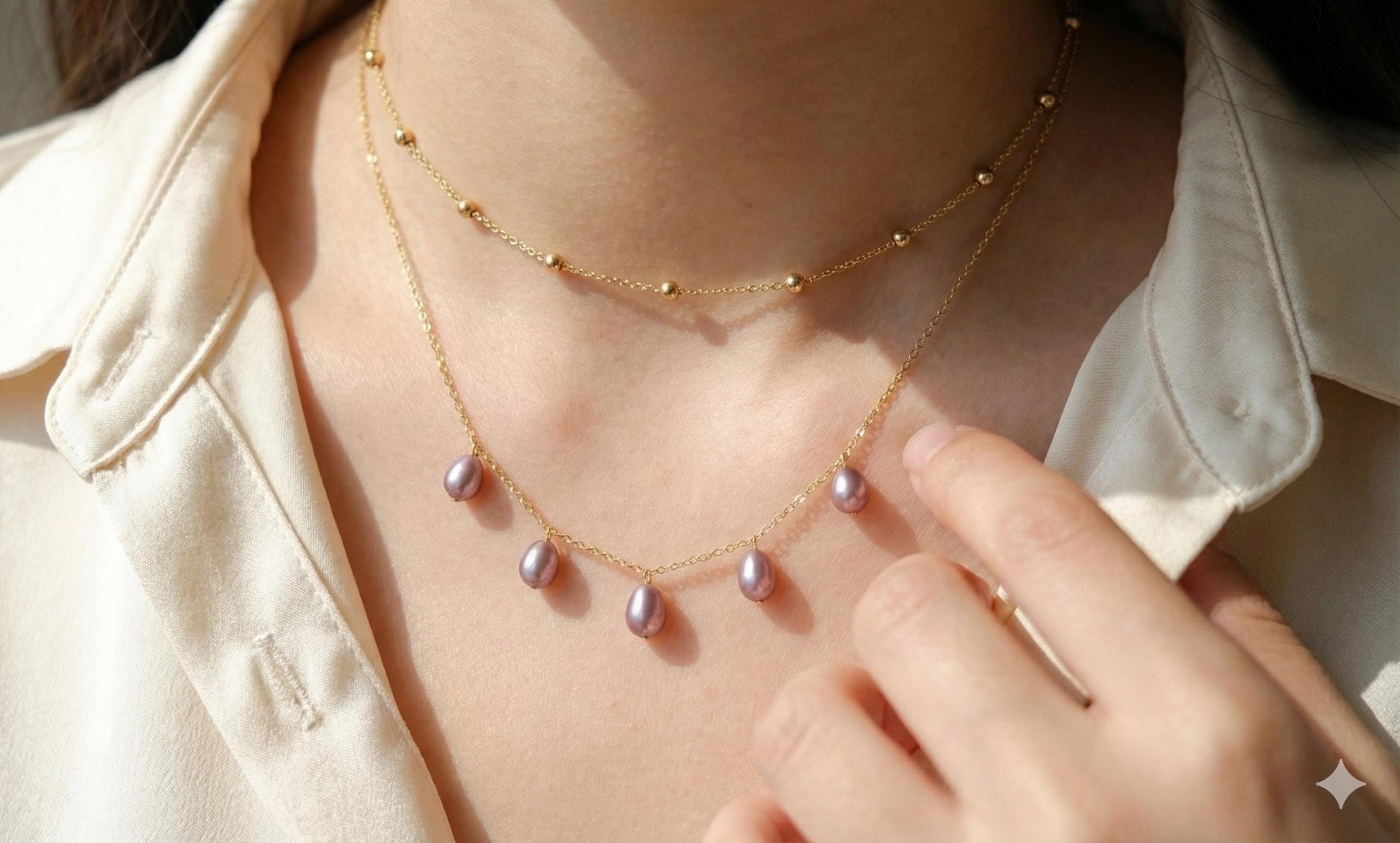 A CAELLIA dainty lavender freshwater pearl necklace on a 14K gold plated chain.