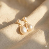Caellia 14K gold plated sterling silver earrings featuring teardrop freshwater pearls.