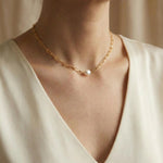 A Caellia 18K gold paperclip chain necklace featuring a single baroque freshwater pearl.