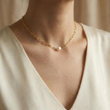 A Caellia 18K gold paperclip chain necklace featuring a single baroque freshwater pearl.