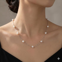 CAELLIA dainty freshwater pearl necklace with a 14K gold plated chain on a woman's neck.
