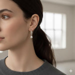 A woman wearing Caellia 14K gold freshwater pearl hoop earrings.