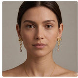 A model wearing Caellia 14K gold bow earrings with dangling freshwater pearls.