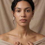 Model wearing matching freshwater pearl circle stud earrings with a classic bridal and occasion look