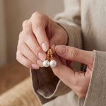 Pearl earrings listing image - Editorial hands shot