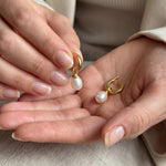 Pearl earrings listing image - Editorial hands shot