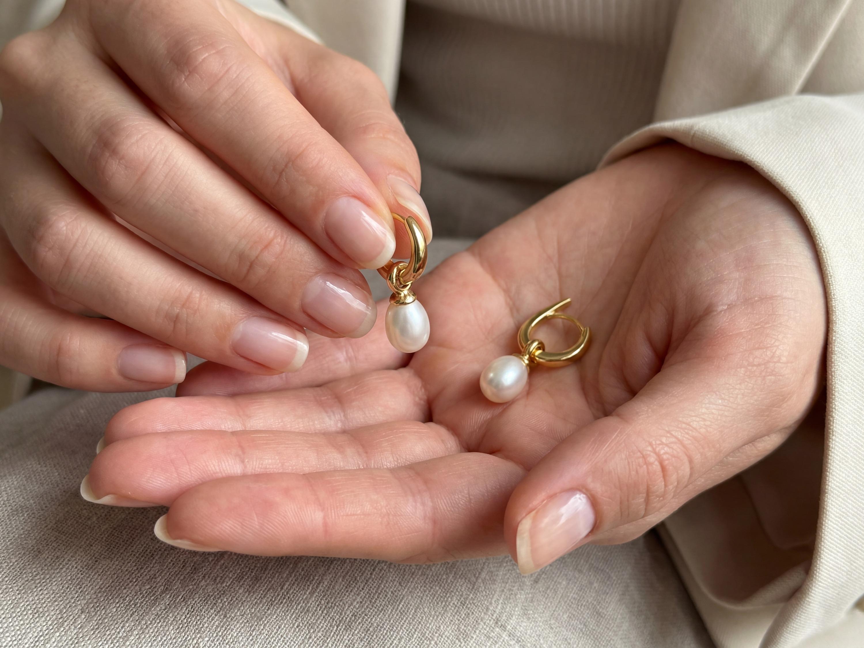 Pearl earrings listing image - Editorial hands shot