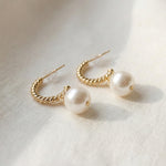 Close-up of twisted 14K gold plated sterling silver half hoops with pearl drops