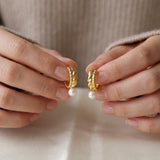 Pearl earrings listing image - Editorial hands shot